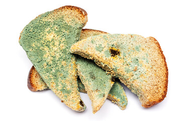 Moldy bread isolated on white background. Rotten and uneatable.