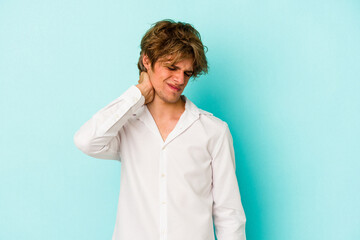 Young caucasian man with make up isolated on blue background  having a neck pain due to stress, massaging and touching it with hand.