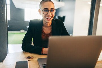 Cheerful businesswoman smiling during a virtual meeting