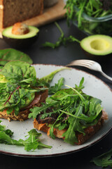 Sandwiches with salmon, avocado and salad