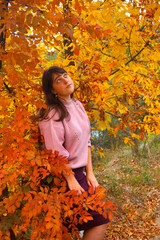 Girl in the autumn wood