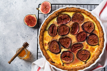 Fig Tart. Delicious tart with fresh figs and goat cheese on rustic wooden table. Top view