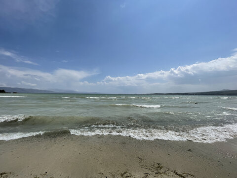 Landscape of Lake Sevan under a blue cloudy sky on a sunny day in Gegharkunik, Armenia