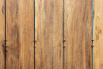 Facing the building with a ventilated facade. Wood texture, brown wood pattern. Close-up background.