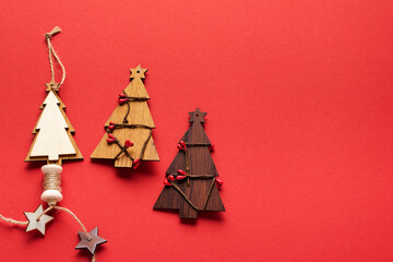 Old Christmas objects wooden fir tree and red cord, snowflakes on red background. Christmas banner. Top view. Flat lay. Mock up.