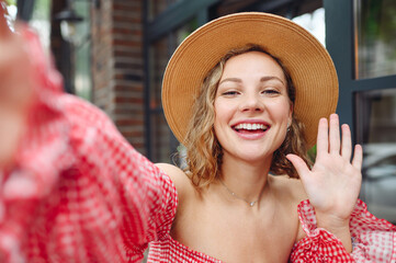 Close up young smiling fun woman 20s wear pink dress hat doing selfie shot pov on mobile phone...