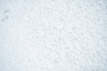 Fototapeta na wymiar The texture of white untouched snow lying on the road