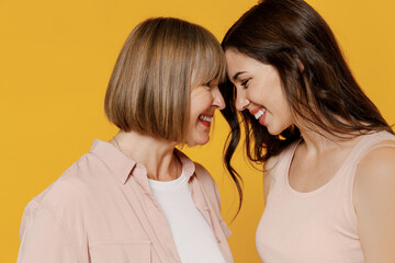 Side view two young tender happy lovely smiling daughter mother together couple women in casual...