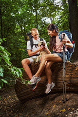 Merry couple having fun with pet in forest