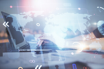 Double exposure of woman hands working on computer and world map hologram drawing. International technology business concept.