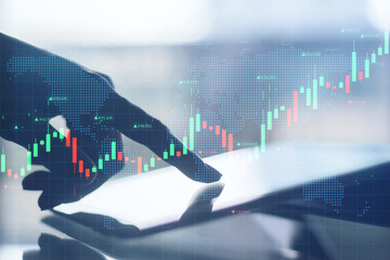 Close up of backlit hand using digital tablet with glowing forex chart. Trade and communication concept. Double exposure.