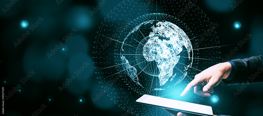 Poster Businessman hand pointing at tablet with glowing globe hologram on blue bokeh background with mock up place. Digital interface and global innovation.