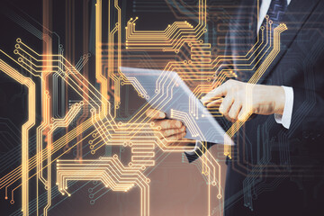 Double exposure of man's hands holding and using a digital device and tech theme hologram drawing. Technology concept.