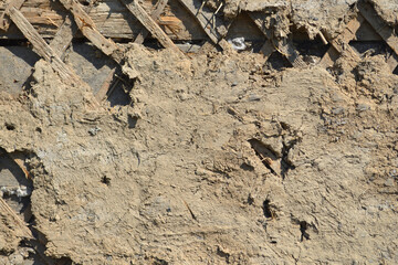 Plaster on an old wooden wall, upholstered with a rail