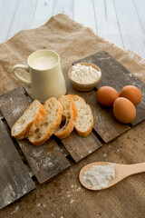 Ciabatta bread, flour and eggs on wooden background, baking ingredients, bakery