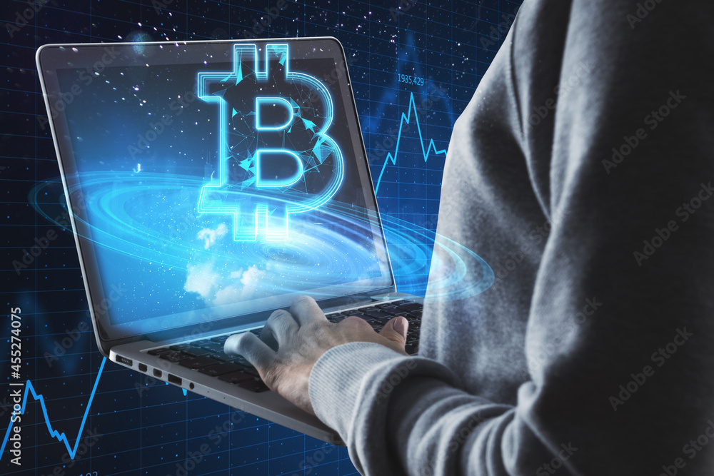 Poster Close up of hacker hands using laptop with creative glowing polygonal bitcoin city hologram on blurry blue background. Cryptocurrency, theft and finance concept.
