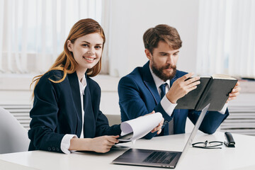 man and woman managers work together in front of laptop office technology