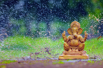 Water splash on lord ganesha sculpture. celebrate lord ganesha festival.