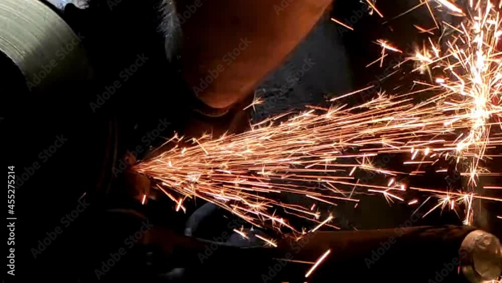 Poster cutting car part in slow motion with sparks in the car workshop.