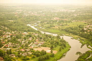 Aerial view of Kuldiga town, Venta river and long brick bridge in spring morning, Latvia.