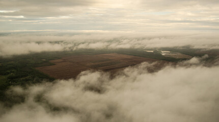 Aerial view of bog and peat harvesting field on a foggy spring morning.