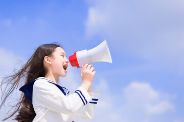 Teenager student girl shouting and announcing with megaphone