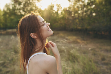 attractive woman in a field in nature sun freedom