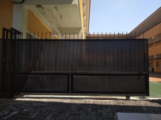 The black sliding fence has a pattern. located in school