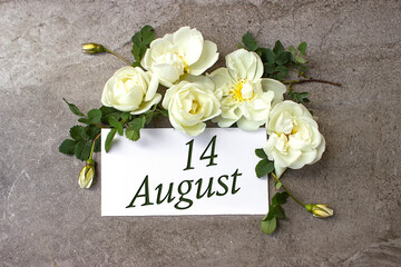 August 14th. Day 14 of month, Calendar date. White roses border on pastel grey background with calendar date. Summer month, day of the year concept.