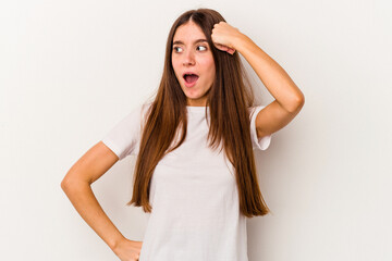 Fototapeta premium Young caucasian woman isolated on white background being shocked, she has remembered important meeting.