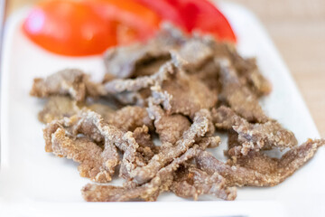 Close up delicious Turkish Edirne stlye pan-fried liver and tomato.