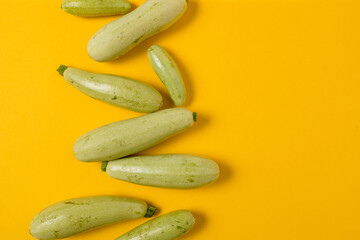 Fresh vegetable marrow isolated on yellow background