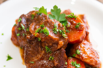 Close-up of pork stew with carrots and parsley