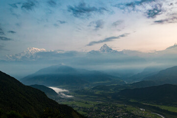 Obraz na płótnie Canvas Looking across the Pokhara Valley to the Himalayas and Fish Tail Mountain from Sarangkot at sunrise