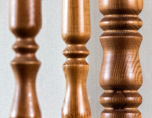 Element of a wooden interior staircase. Wooden baluster close-up.