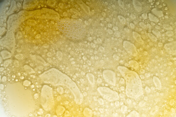 Abstract photo using a combination of liquid, oils forming distinct patterns.