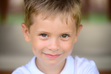 Portrait of young smiling boy in outdoors. Image with shallow DOF. - 455286413
