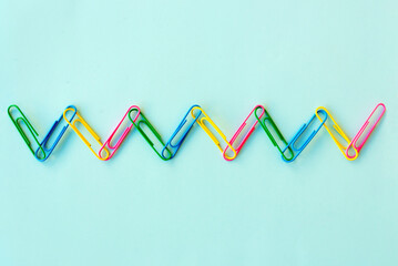 Colorful paper clips stuck together in a chain. Concept of human diversity, equality, connection, and friendship