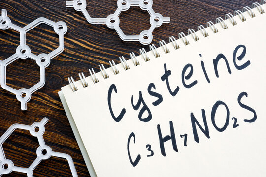 Cysteine with handwritten chemical formula in the notepad.