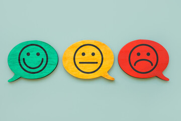 Customer satisfaction index concept. Smiley faces on the plates.