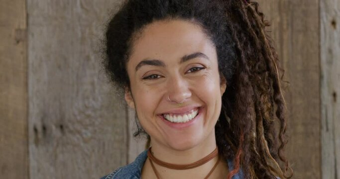 Portrait mixed race woman with dredlocks smiling