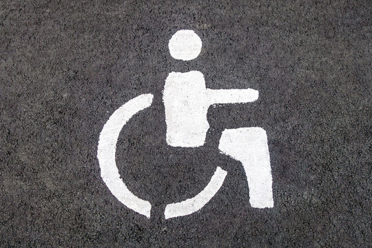 Road markings on the asphalt. Parking sign for disabled people cars