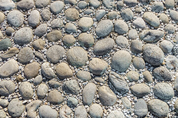 Stacked large rounded stones surrounded by small pebbles or rubble