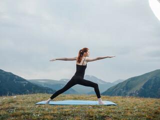 woman outdoors in the mountains meditation exercise yoga fresh air