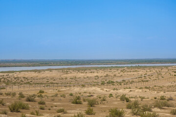 Panorama of Uzbek-Afghan border. In foreground is territory of Uzbekistan, beyond Amu Darya River lies Afghanistan