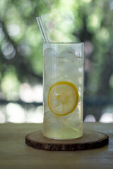 Glass with lemon water and ice cubes