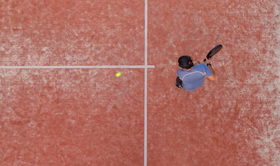 Top view of a padel player who is going to hit the ball during a padel match.