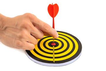 Hand holding dart on the target
