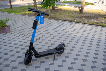 The electric scooter is on a concrete tile. Scooter rental service. Urban transport. Kiev. Ukraine. 04/09/2021