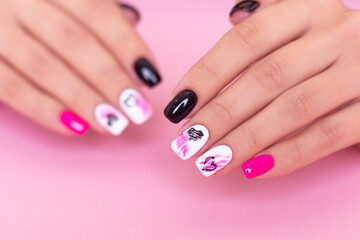 Obraz na płótnie Canvas Beautiful female hands with fashion manicure nails, hearts and Valentine's day design, on pink background
